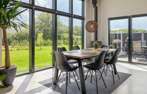 a dining room with a table and chairs at Holiday Home Pilemose Ii in Skovby