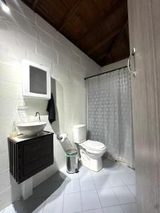 La salle de bains est pourvue de toilettes et d'une télévision murale. dans l'établissement Casa Verano la rumbita Naturaleza, Piscina y Rio, à Santa Fe de Antioquia