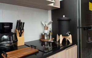 a kitchen with a black counter top with a coffee maker at Uleu Zona Viva in Guatemala +27 photos
