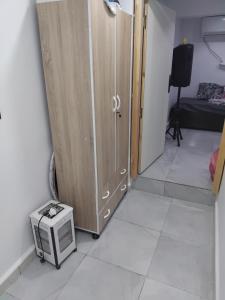a room with a cabinet and a microwave on the floor at Guets in Constantine