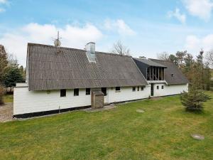 a white barn with a roof on a field at 10 person holiday home in Fur in Fur