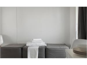 a white room with two beds and towels at Athens View Loft - 06 in Athens