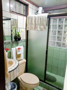 a bathroom with a toilet and a shower and a sink at Villa Guarias in Puntarenas +26 photos