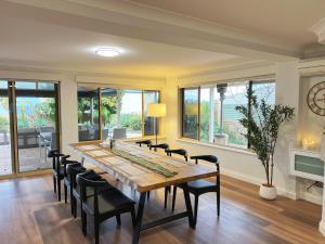 a dining room with a long table and chairs at Ocean View Sunset Resort in Perth +45 photos
