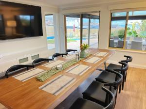 a conference room with a large wooden table and chairs at Ocean View Sunset Resort in Perth