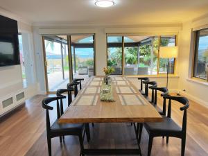 a large dining room with a long table and chairs at Ocean View Sunset Resort in Perth