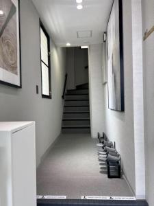 a hallway with a row of chairs and stairs at Jasmin Nishikimachi IV - Vacation STAY 13089v in Takamatsu