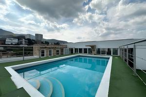 a swimming pool on the roof of a building at Studio in the Flora jacuzzi406 in Cali
