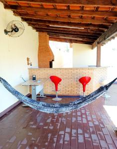 a hammock in a room with a table and two chairs at Eventinho in Sao Jose do Rio Preto