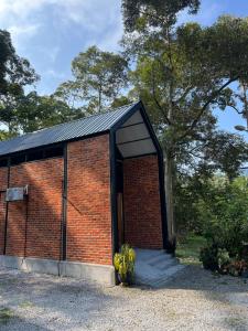 a brick building with a bunch of bananas in front at Royal Brick Cottage, Jelebu in Kuala Kelawang +3 photos