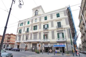 a large white building on the corner of a street at Villa Quaranta in Portici +19 photos