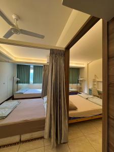 a bedroom with two beds and a ceiling fan at 魚門中興新村 in Nantou City
