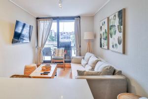 a living room with a couch and a table at HOM I Depto con Gran Terraza con Vista al Lago in Puerto Varas