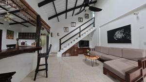 a living room with a couch and a staircase at Villa Cris Minca in Minca