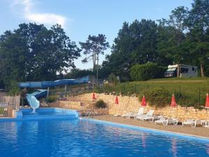 a swimming pool with chairs and a water slide at Chalet confortable 8 pers, 3 ch, poêle à bois - API-1-52-154 in Salles