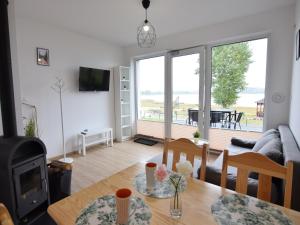 a living room with a table and a fireplace at Cottage by Kiedrowickie Lake with Boat Access in Kiedrowice