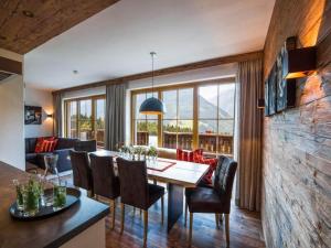 a dining room and living room with a table and chairs at Chalet with Sauna and Natural Pool in Neukirchen am Großvenediger