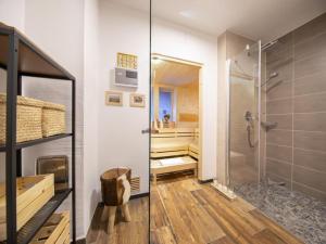 a bathroom with a walk in shower and a glass door at Cozy Mountain Chalet with sauna in Neukirchen am Großvenediger +41 photos