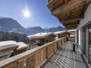 a balcony of a house with snow covered mountains at Stylish Chalet by Ski Slopes in Neukirchen am Großvenediger