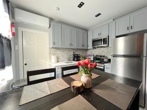 a kitchen with a table with a vase of flowers on it at 3 bedrooms in 2nd floor Modern Brooklyn home, Close to J train in Brooklyn