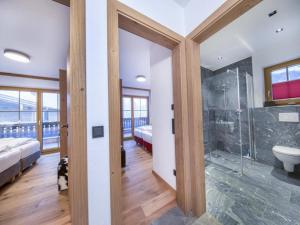 a bathroom with a shower and a toilet and a sink at Chalet with shared swimming pool in Neukirchen am Großvenediger +41 photos