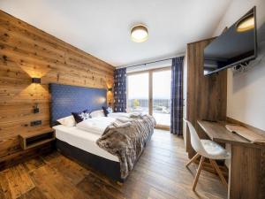 a bedroom with a large bed and a desk at Ski-Friendly Chalet in Neukirchen in Neukirchen am Großvenediger