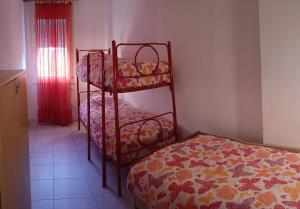 a bedroom with two bunk beds and a bed at Lido degli Estensi - condominio Ravenna in Lido degli Estensi