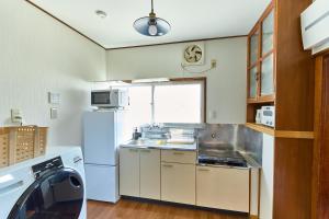 Η κουζίνα ή μικρή κουζίνα στο Stay as Local mizue