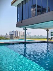 a large pool of water with a building in the background at The Pool Suite Premium Room-Jonker in Melaka
