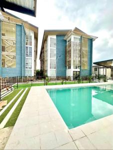 an image of a swimming pool in front of a building at Cozy 2BR Condo near Airport- Perfect for travelers in Lapu Lapu City