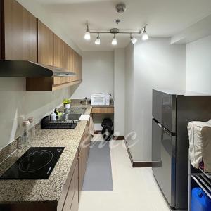 a kitchen with a sink and a refrigerator at A Space Close to Transits or Airport in Manila +6 photos