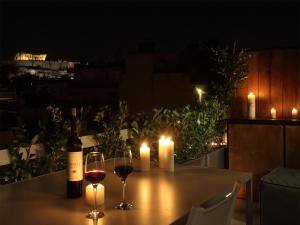 アテネにあるAthens View Loft - 01のワイン2杯とキャンドル2本のテーブル