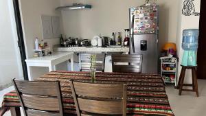 a kitchen with a table with chairs and a refrigerator at Habitación Chero Premiun in Comalcalco