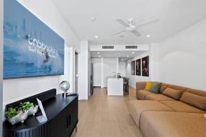 a living room with a couch and a table at Queens Wharf Luxe Retreat -Brisbane CBD, Pool, Spa in Brisbane +29 photos