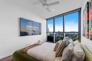 a bedroom with a large bed and a large window at Queens Wharf Luxe Retreat -Brisbane CBD, Pool, Spa in Brisbane