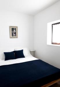 a bedroom with a large bed with a blue blanket at Apartments Marina-Mare in Poreč