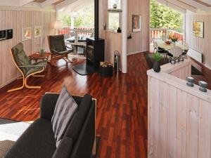 a living room with a couch and a table at 6 person holiday home in Hadsund in Øster Hurup +17 photos