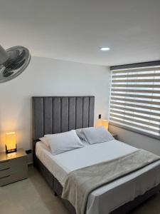 a bedroom with a large bed and a window at Apartamento vacacional San Gil in San Gil
