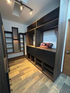 a bathroom with black cabinets and a wooden floor at New modern house in Qro in El Pueblito