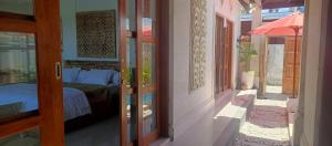 a bedroom with a bed and an open door at Padma Laya Private Villa 2BR in Sukawati +15 photos