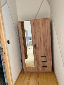 a wooden door with a mirror in a room at Shark in Liepāja