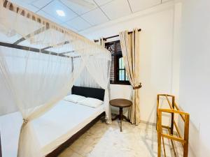 a bedroom with a bunk bed and a ladder at Dills Villa in Weligama