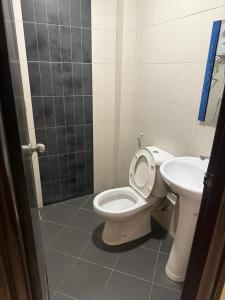 a bathroom with a toilet and a sink at Five Hotel in Seremban