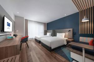 a hotel room with a bed and a couch at Holiday Inn Express Guiyang Century City Mall By IHG in Guiyang
