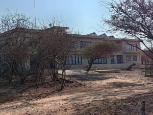 a large building with trees in front of it at Wildlife Oasis in Marloth Park
