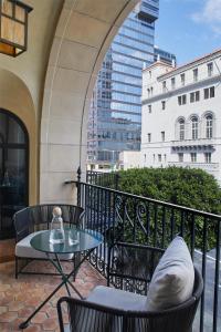 a patio with a table and chairs on a balcony at Hotel Figueroa, Unbound Collection by Hyatt in Los Angeles +92 photos