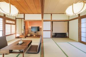 a living room with a table and a tv at Laughter in Fuchu