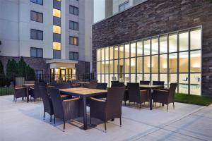 a patio with tables and chairs in front of a building at Hilton Garden Inn Nashville Opryland in Nashville