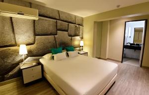 Giường trong phòng chung tại Mariel Hotel Boutique