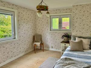 a bedroom with a bed and a desk and a window at Big House With A View Over Forest Lake in Hölö